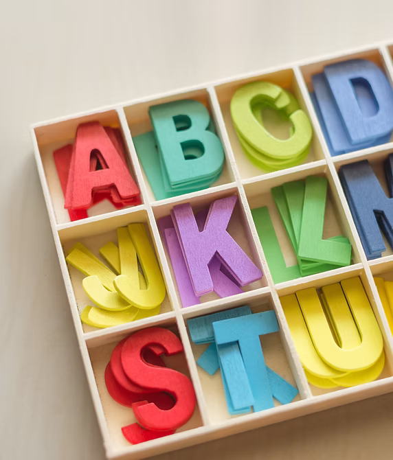 Colorful alphabet letters in wooden compartments