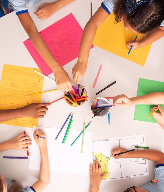 Kids drawing together, top view