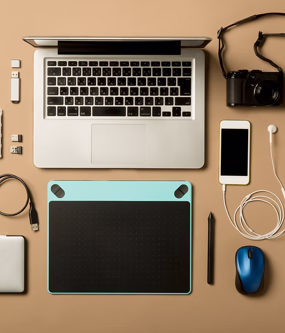 Desk with laptop, tablet and devices